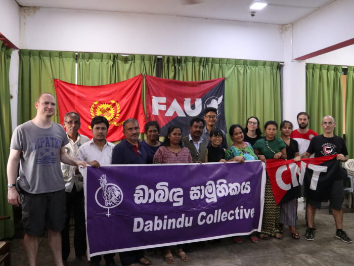 Activists behind a Dabindu Collective Banner