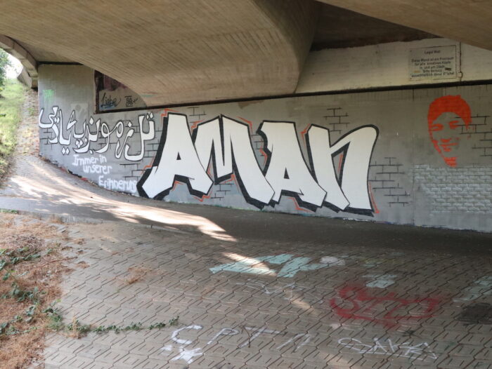 Grafitti für Aman Alizada an einer Wand in Stade