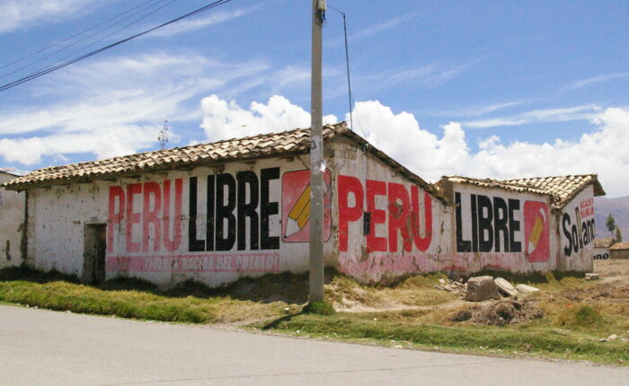 Die Wände eines Hauses sind mit der Aufschrift Peru Libre und dem Symbol, einem Stift, bemalt