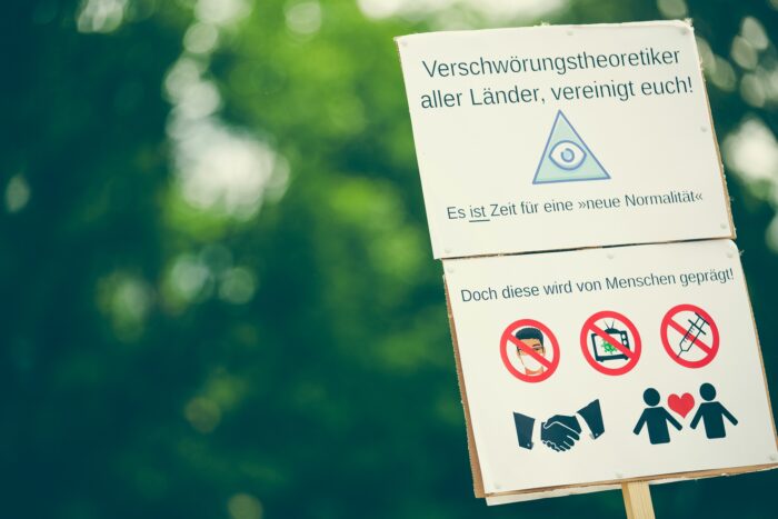 Ein Plakat mit der Aufschrift: "Verschwörungstheoretiker aller Länder vereinigt euch"